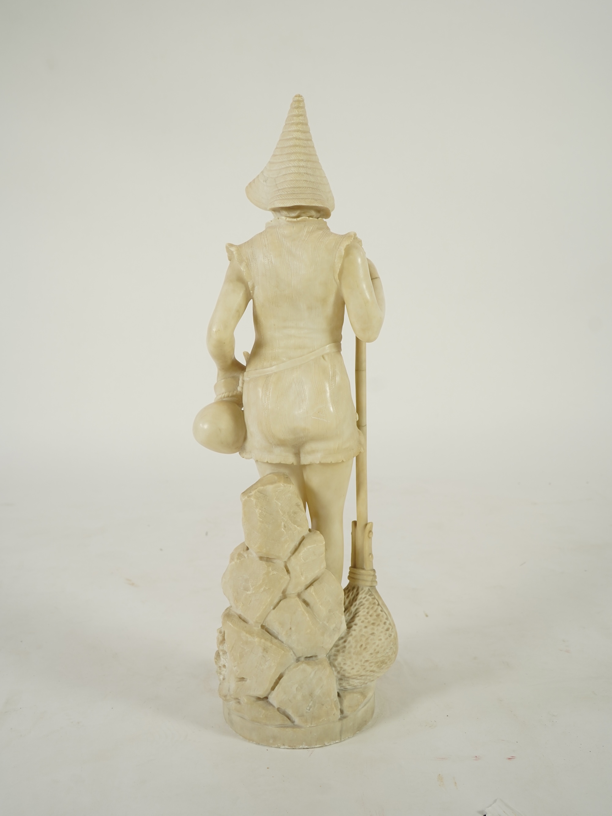A Continental alabaster figure of a woman fishing, early 20th century